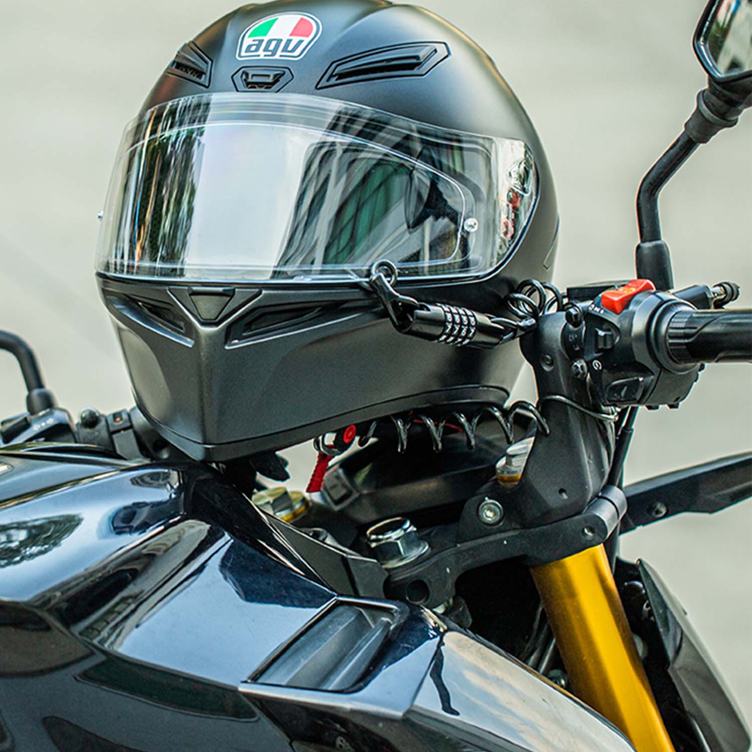 Image of the 4 digit combination lock being used to secure a motorbike helmet to a motorcycle