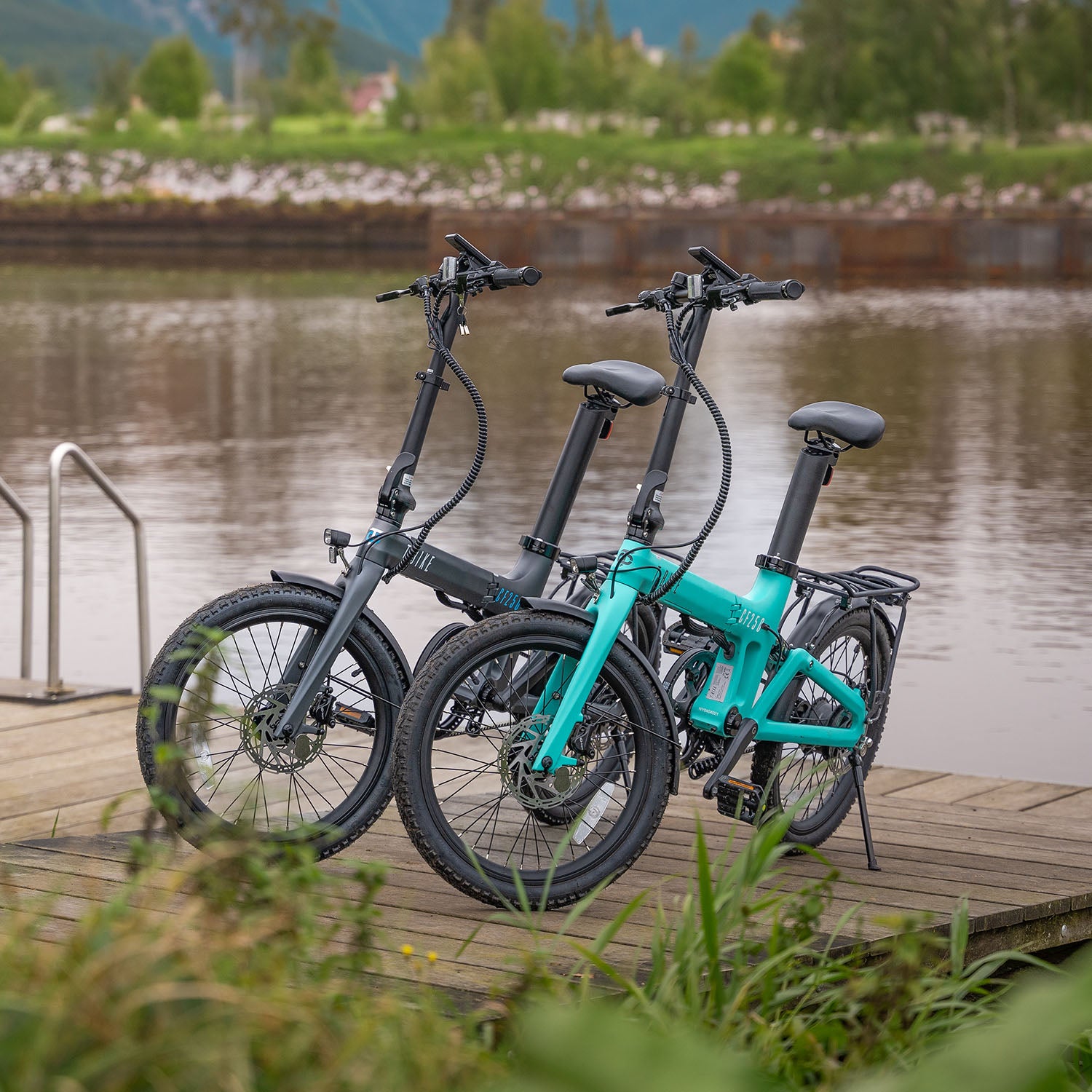Lifestyle image of the Turquoise and black Carbon Fibre 250 folding E-Bike on a dock