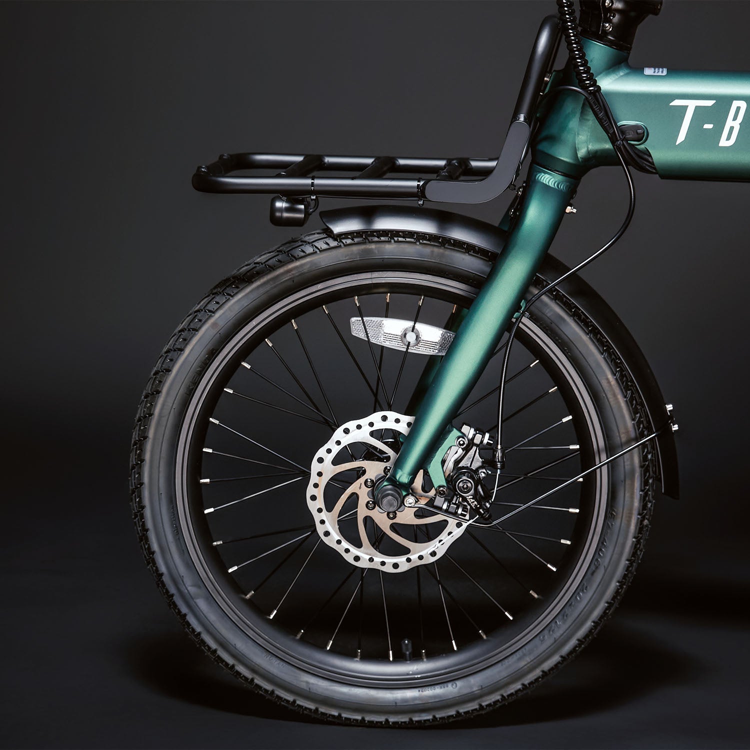 Side view Image of the Green CITY 250 folding E-Bike displaying the front quarter of the bike including the luggage rack and disc brakes
