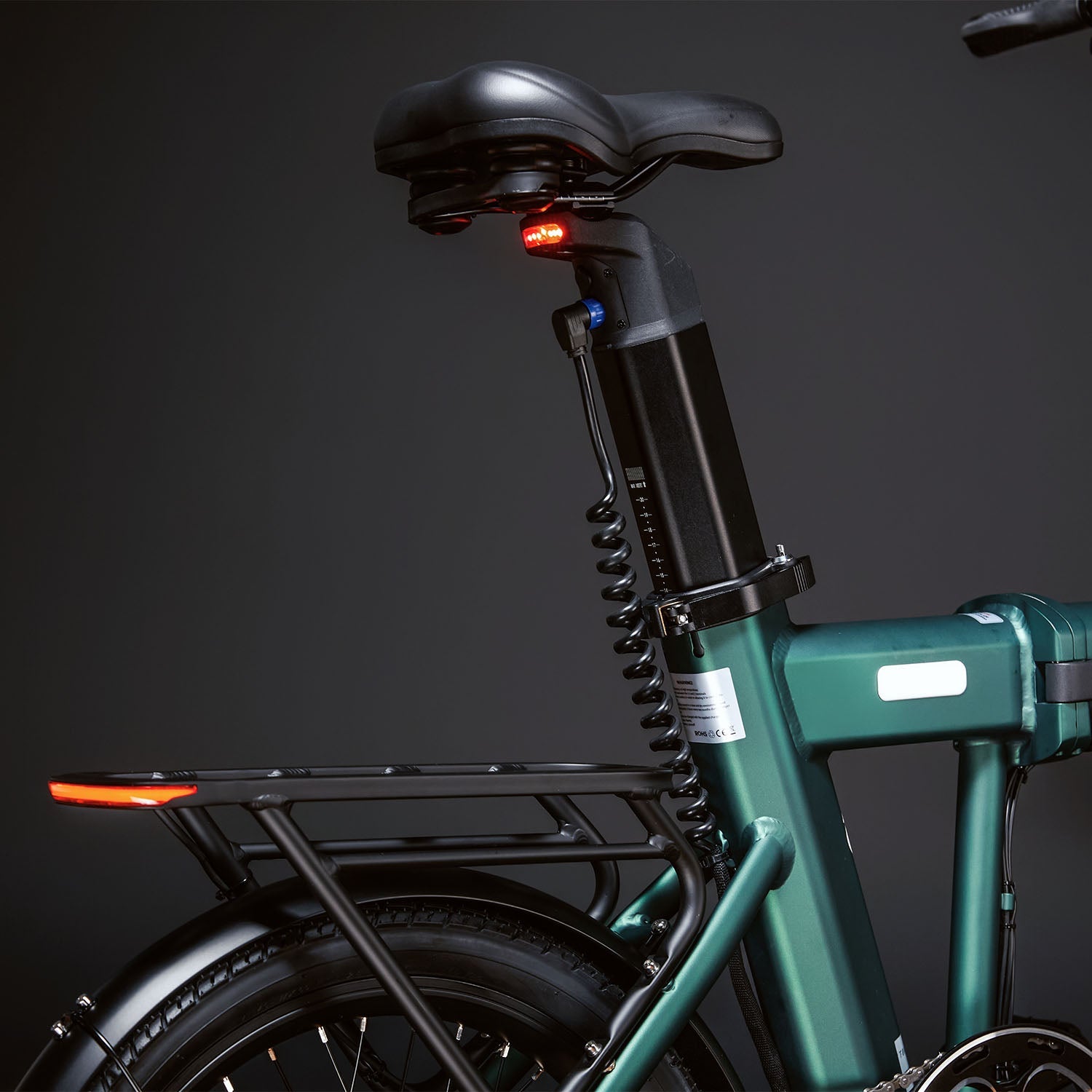 Rear view Image of the Green CITY 250 folding E-Bike displaying the rear quarter of the bike including the luggage rack and focusing on the built in lights