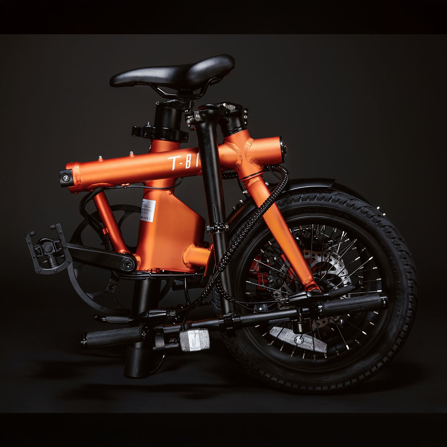 Image of the orange Compact Rider folded up compactly