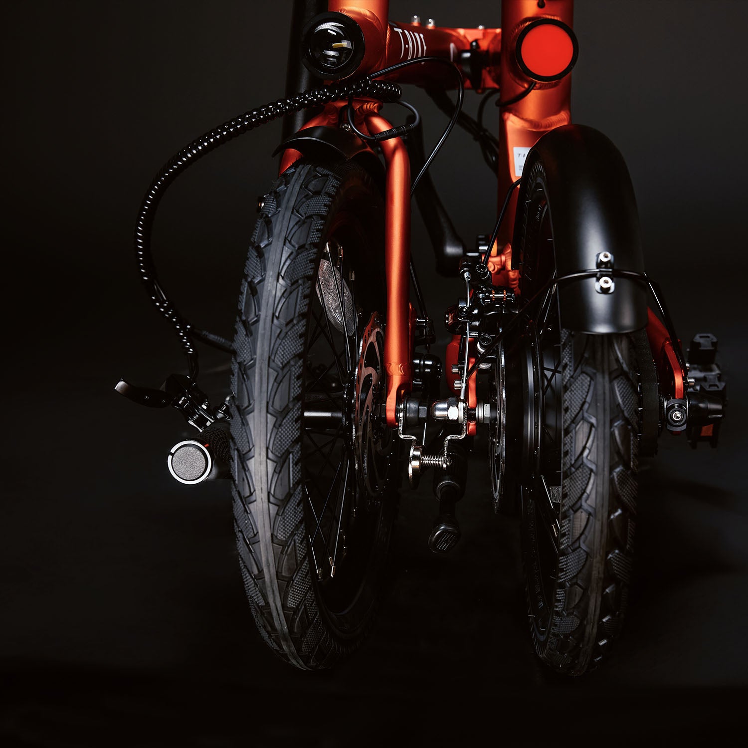 Image of the orange Compact Rider folded up compactly