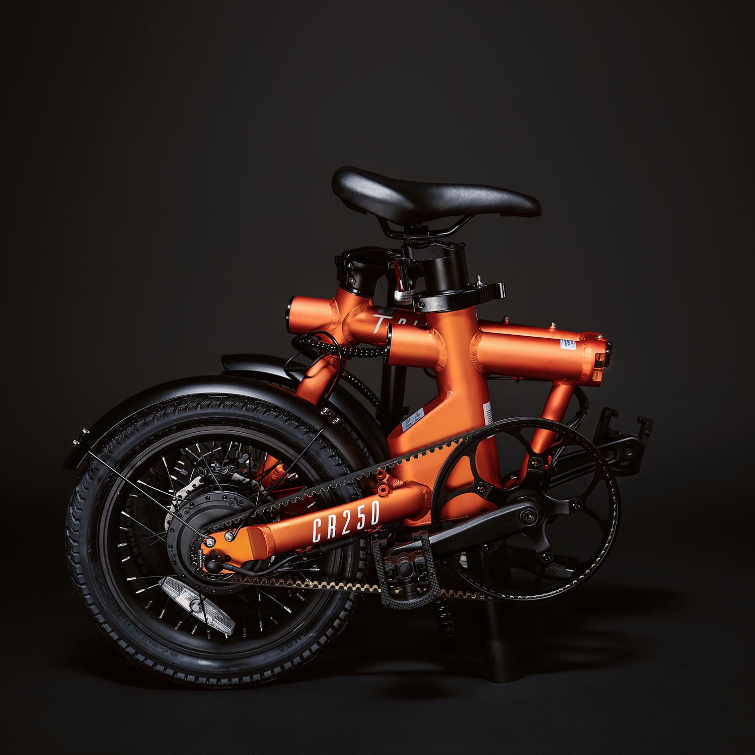Image of the orange Compact Rider folded up compactly