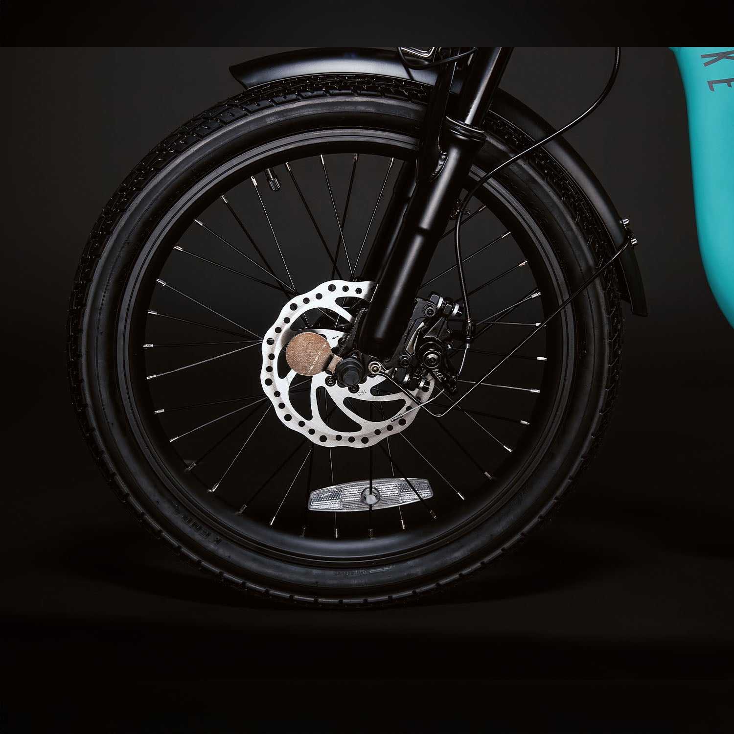 Image of the front wheel of the Turquoise Low Rider 250 viewed from the side