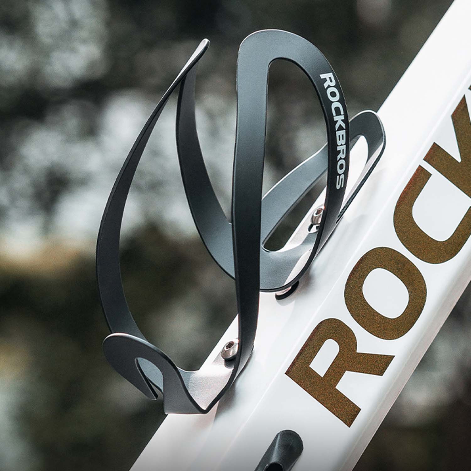 Image of the swan shaped bottle holder attached to the frame of a bike via screws