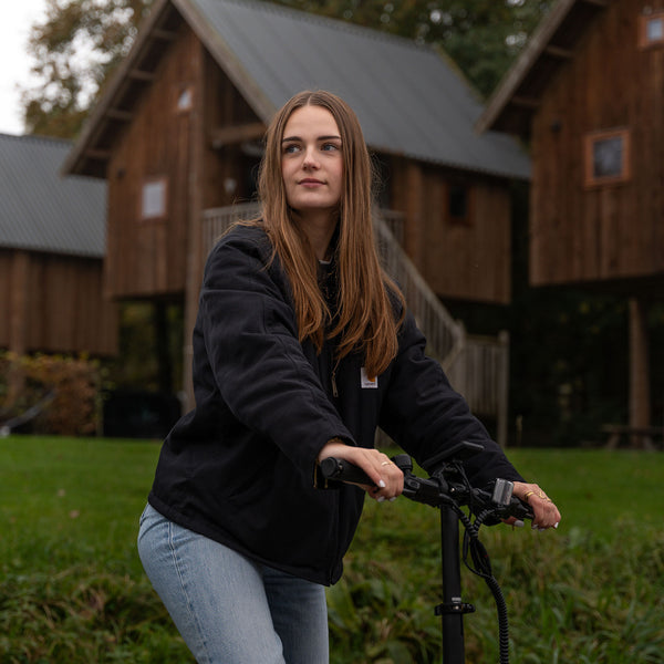 Image of a woman riding a Carbon Fibre 250 folding E-Bike
