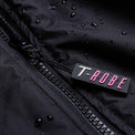Image of water droplets on the surface of the black and pink T-Robe showcasing the waterproof capabilities
