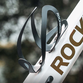 Image of the swan shaped bottle holder attached to the frame of a bike via screws